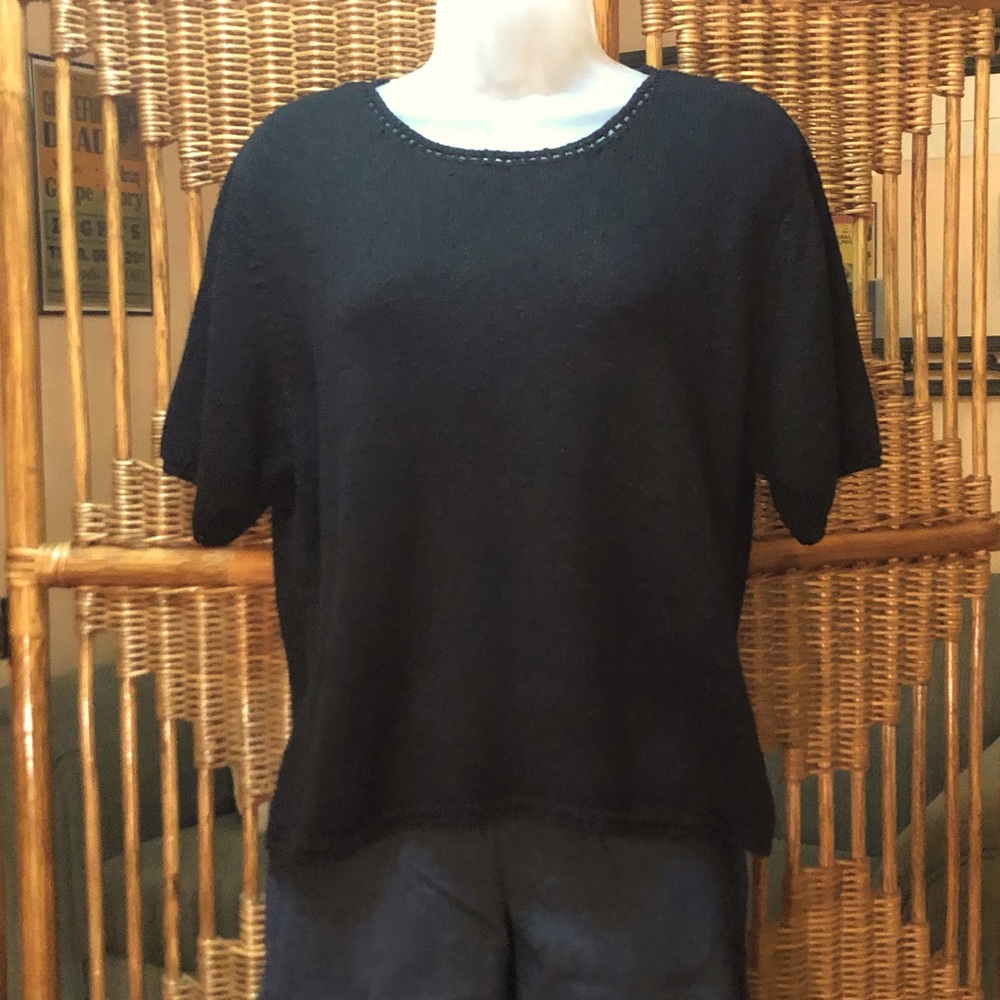 Short sleeved black knit top.